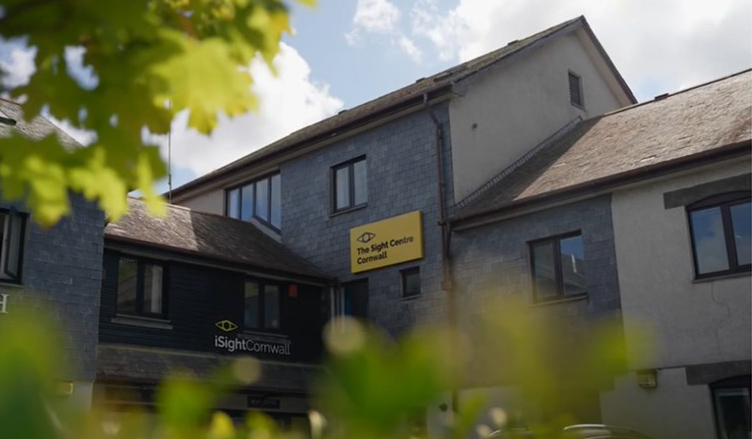 An image of a building with a bright yellow sign which says The Sight Centre Cornwall.