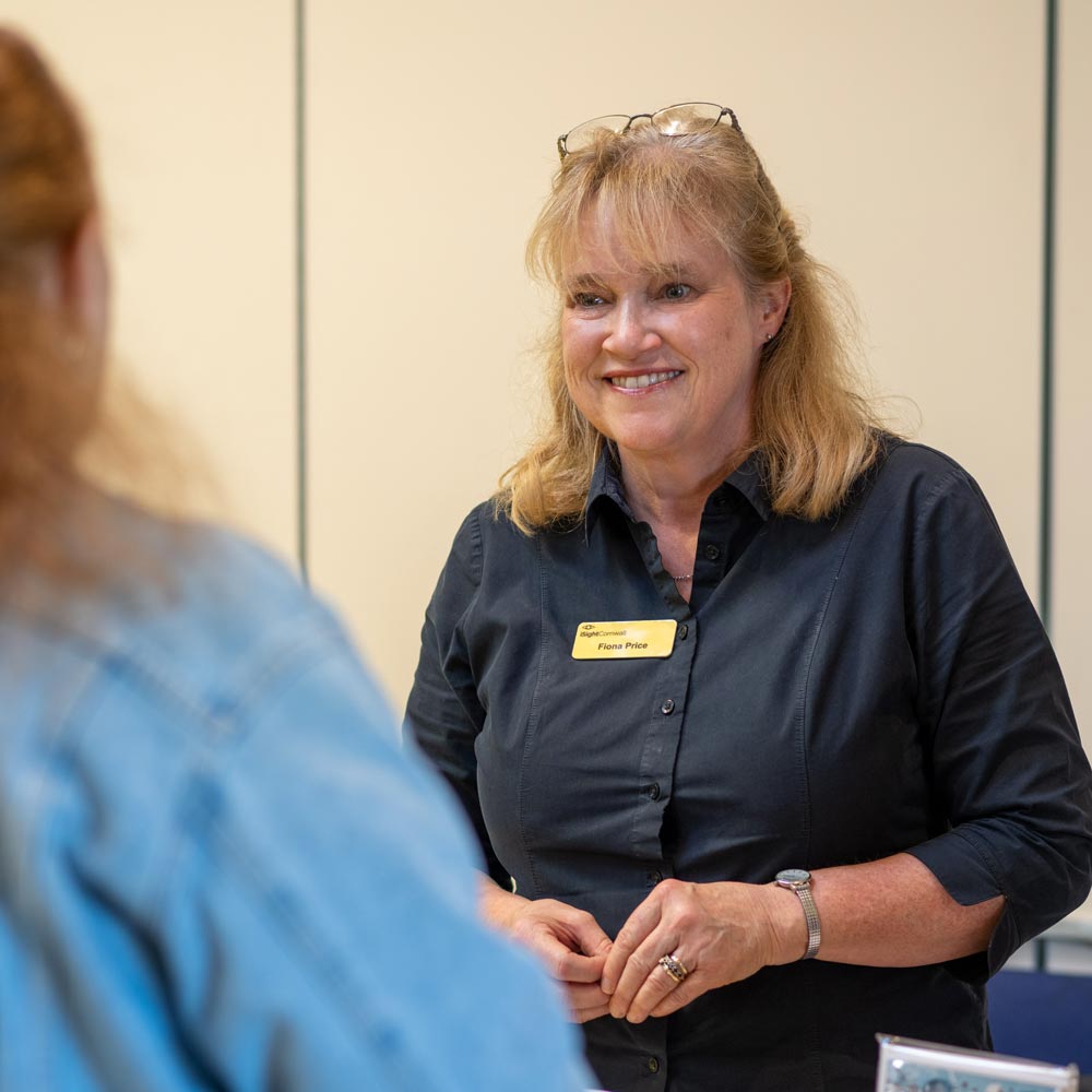 Lady Wearing Black Shirt Talking To Somebody In A Blue Shirt