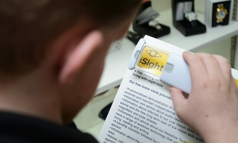 Man Using Magnifier To Read Document