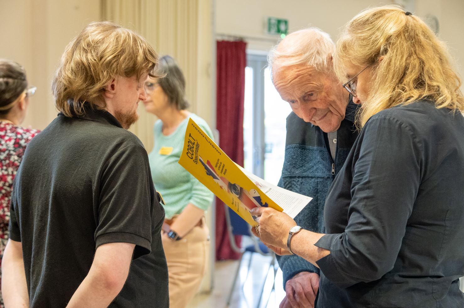 Three People Reading Magazine Article