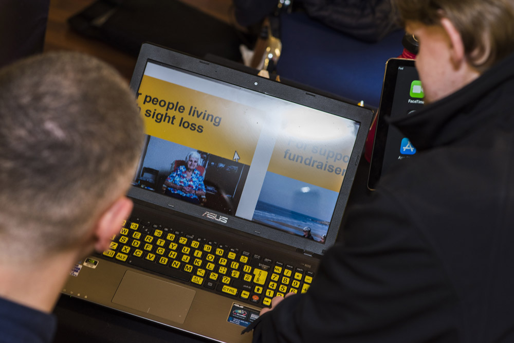 Two Men Using Accessible Laptop