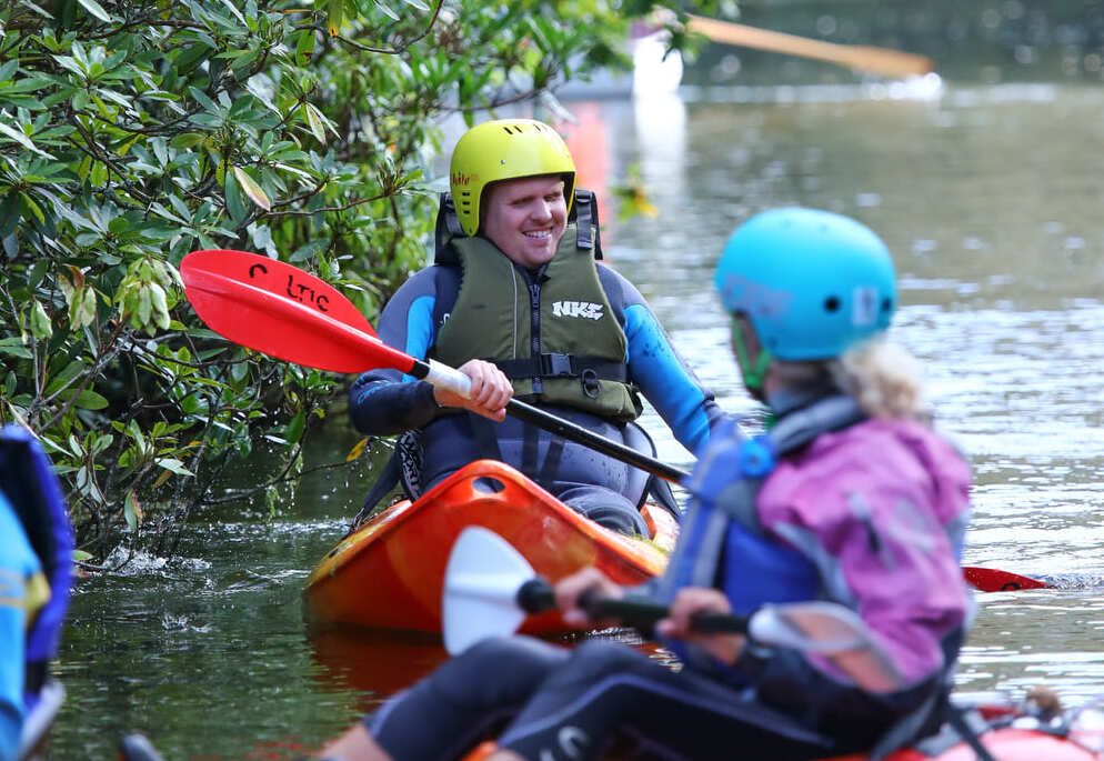 Visually Impaired Man In Kayak Rowing Through River