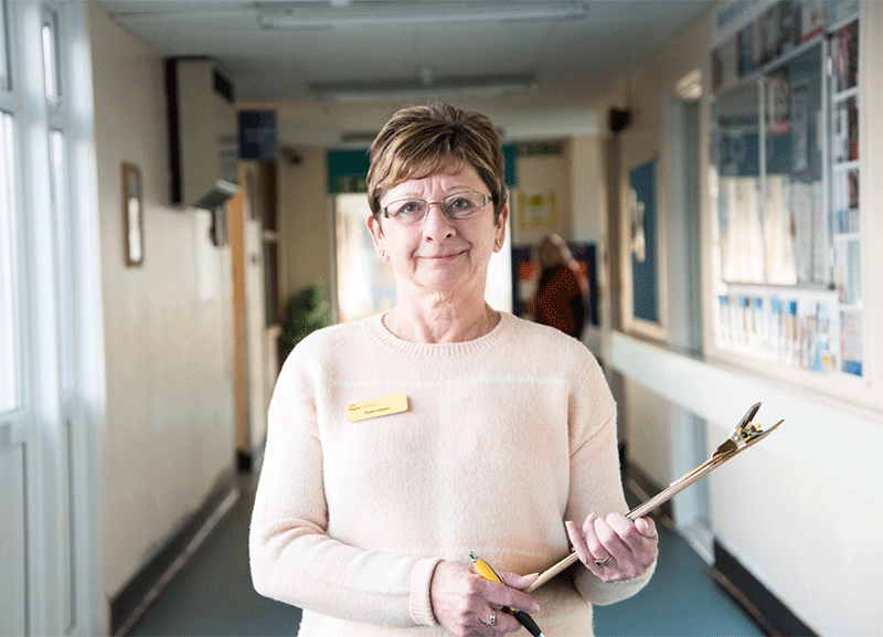 Woman Standing With Clip Board And Pen